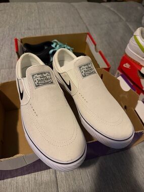 Nike Stefan Janoski Slip-On Suede Sneakers in White with Black Swoosh